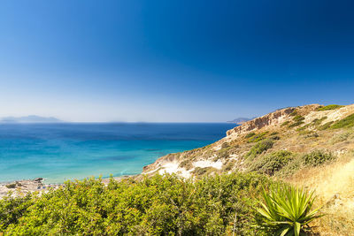 Scenic view of sea against clear blue sky