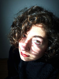 Close-up portrait of teenage girl at home