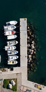 High angle view of boats moored in lake against buildings