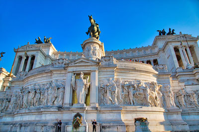 Low angle view of statue against blue sky