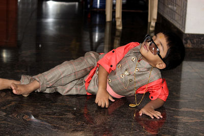 Full length of boy lying on floor