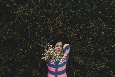 Young woman lying on grassy field