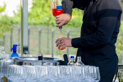 Midsection of man holding drink