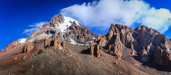 Low angle view of rocky mountain against sky