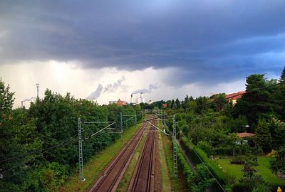 Railroad track against cloudy sky