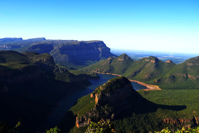 Scenic view of mountains against clear blue sky