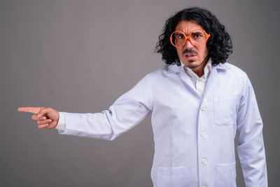 Full length of man standing against black background