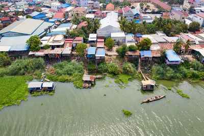 High angle view of houses by river and buildings