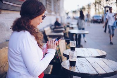 Rear view of woman using mobile phone