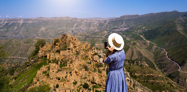 Side view of woman looking at mountains