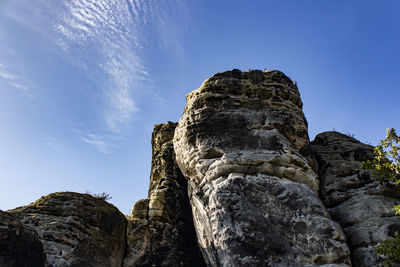 Low angle view of rock formation against sky