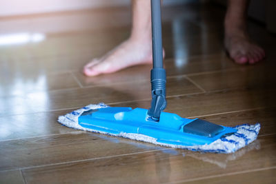 Low section of man cleaning floor
