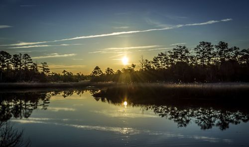 Scenic view of lake at sunset