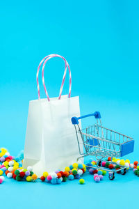 Low angle view of candies on table against blue background