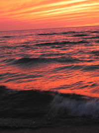 Scenic view of sea against orange sky