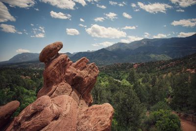 Scenic view of mountain range against cloudy sky