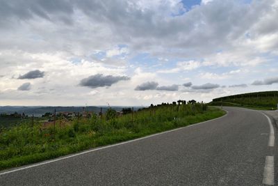 Winding road on the top of a hill with cloudy sky, langhe, piedmont, italy