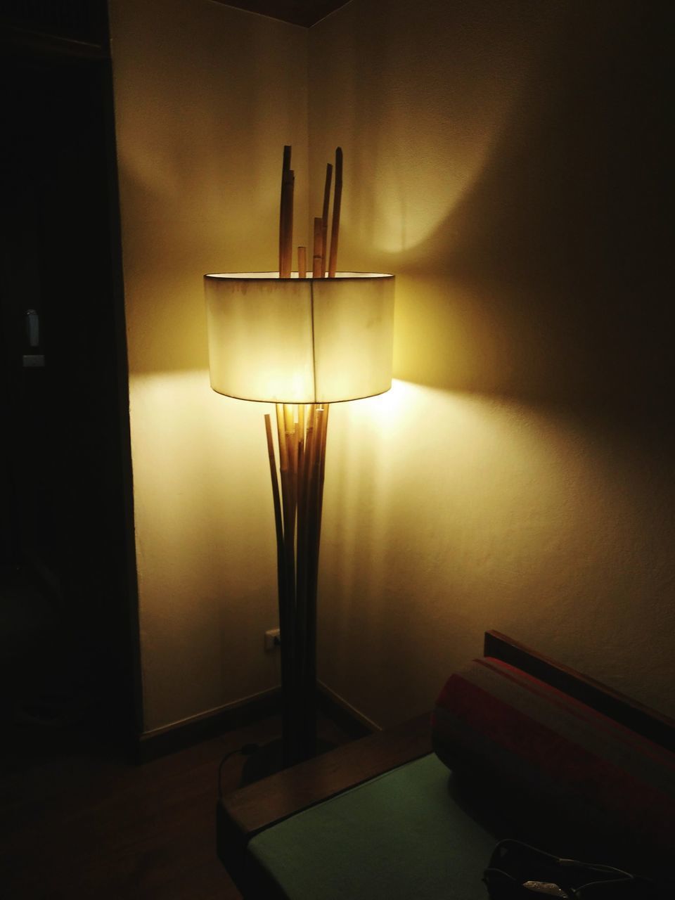 CLOSE-UP OF ILLUMINATED ELECTRIC LAMP ON TABLE