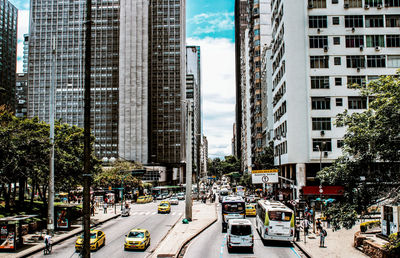 Traffic on road amidst buildings in city