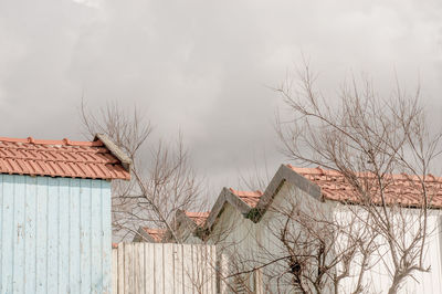 Houses against sky during winter