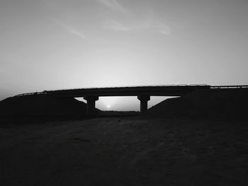 Low angle view of bridge over river against sky