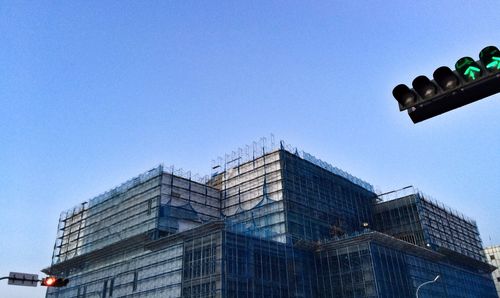 Low angle view of buildings against clear blue sky