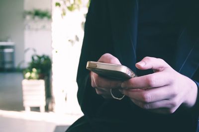 Close-up of man using mobile phone