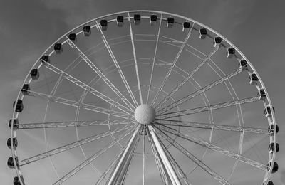 Low angle view of ferris wheel against sky