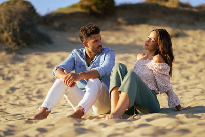 Young couple sitting on beach