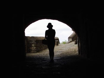 Rear view of silhouette man walking in corridor