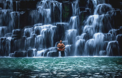 Shirtless man doing yoga at bulingan falls