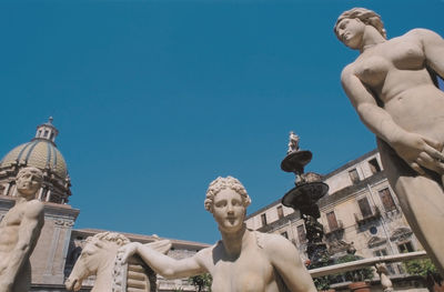 Low angle view of statue against blue sky