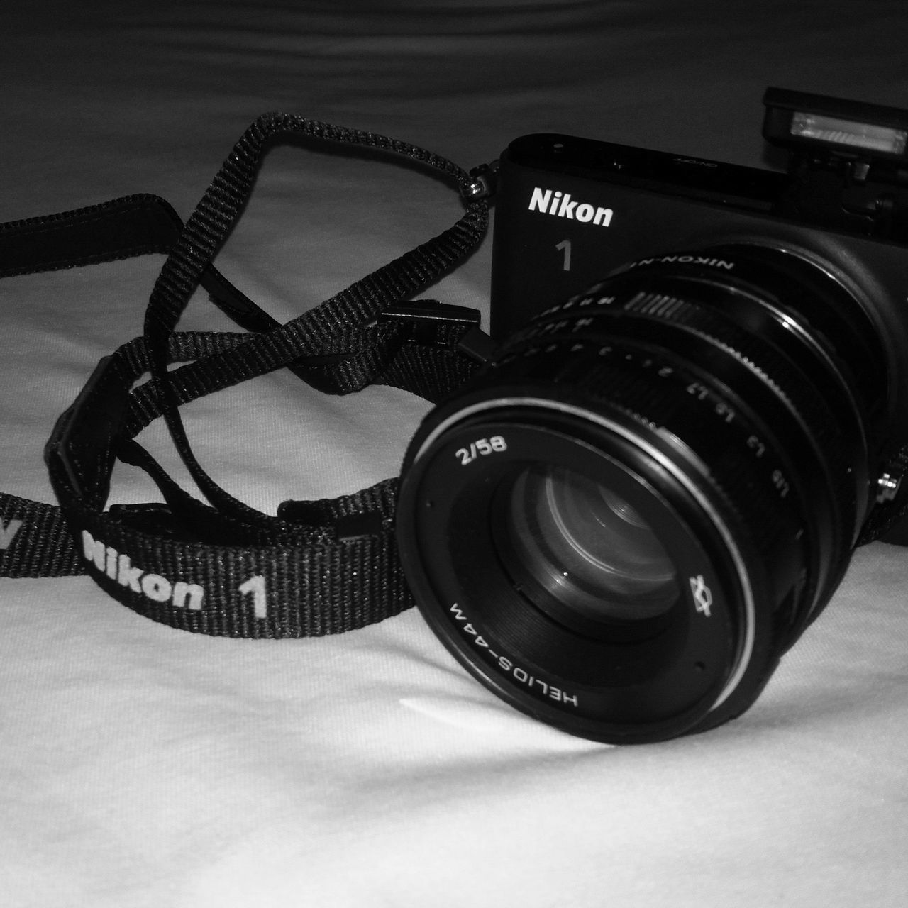 CLOSE-UP OF CAMERA ON TABLE WITH EYEGLASSES