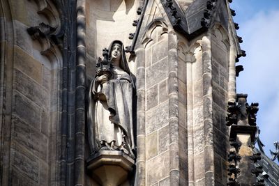 Low angle view of statue against historic building