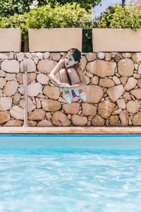 Little child jumping into a pool