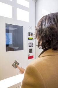 Rear view of woman using smart phone