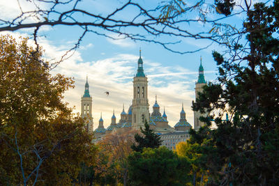 Panoramic view of buildings and trees against sky