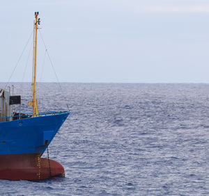 Sailboat in sea against sky