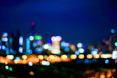 Defocused image of illuminated city at night