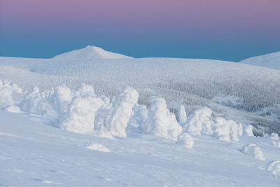 Scenic view of snow covered mountains against sky