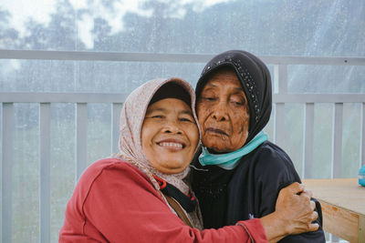 Portrait of old muslim woman hugging her mother