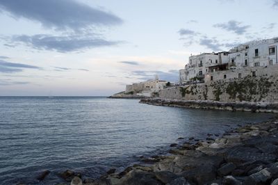 Scenic view of sea against buildings in puglia, south italy