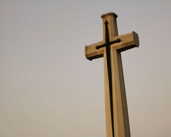 Low angle view of cross against clear sky