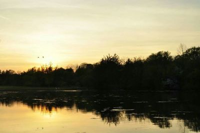 Scenic view of lake at sunset