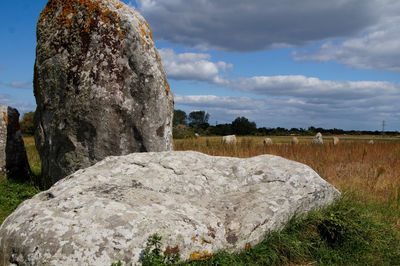 Rocks on field against sky