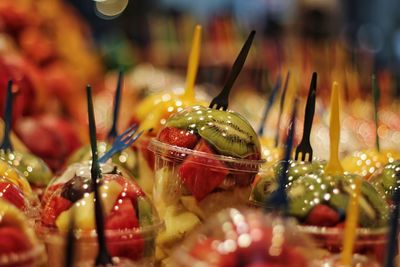 Close-up of fruits in disposable cups