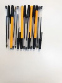 Close-up of colored pencils over white background