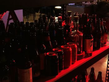 Panoramic shot of bottles on display at night