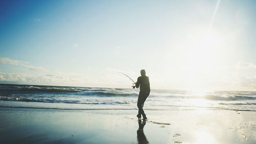 Man fishing at seaside