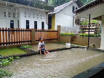 Touching moment of kid to have unforgetable experiences  by let him enjoy  playing  under raindrop